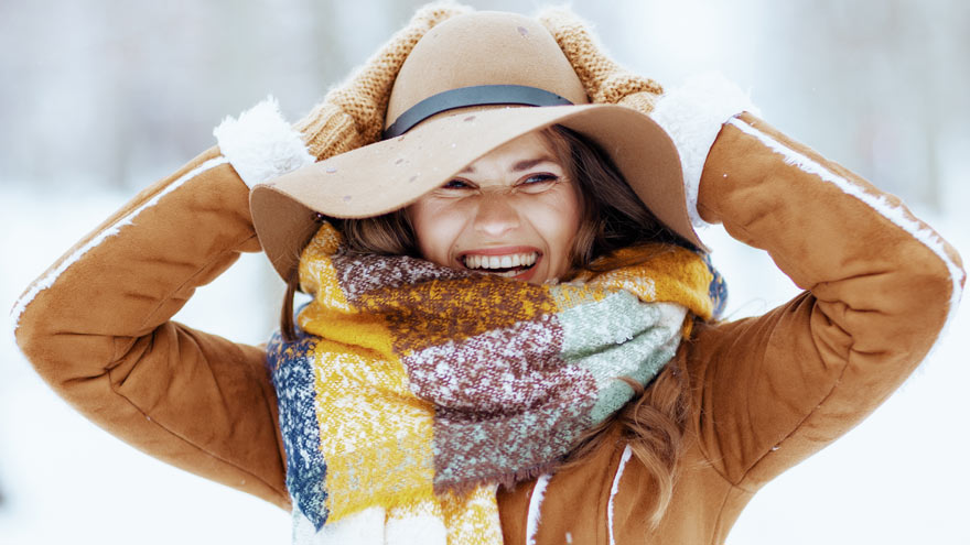 Woman wearing hat and scarf enjoying winter